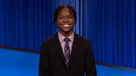 Rotimi Kukoyi smiling on the set of Jeopardy!