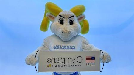 Rameses holding Olympics banner