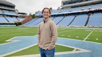 Kyle Lobenhofer stands on field at Kenan Stadium