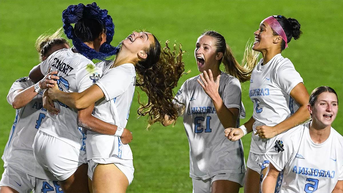 Carolina women's soccer players hug each other on the field after claiming the program's 23rd national title.